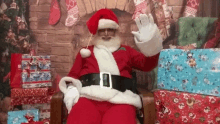 a man dressed as santa claus sitting in a chair