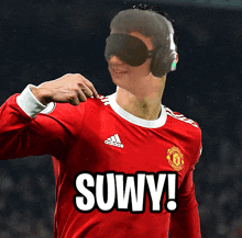 a man wearing headphones and a red adidas jersey with the word suwy on it