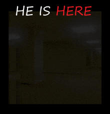 a dark room with the words he is here written on it