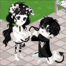 a girl with dalmatian ears is holding the hand of a boy with devil horns