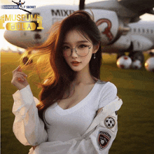 a woman wearing glasses stands in front of a plane that says museum bola on it