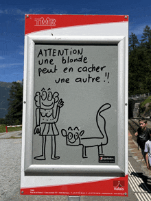 a sign says attention une blonde peut en cacher une autre on it