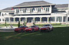 three red sports cars are parked in front of a large white building