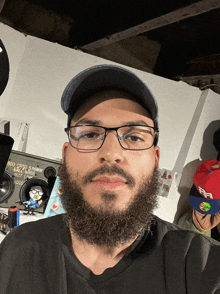 a man with glasses and a beard is standing in front of a boombox