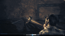 a video game screen shows a man holding a flashlight in a dark room