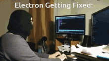 a man wearing a mask is typing on a keyboard with the words electron getting fixed written above him