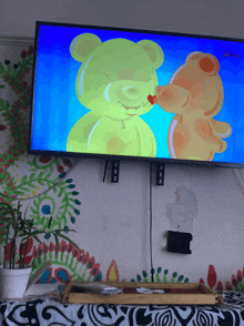 a tv screen shows two teddy bears kissing