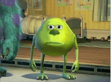 a green monster from monsters inc is standing next to a blue monster in a bedroom .