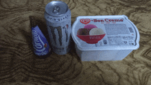 a can of monster sits next to a container of bon crema