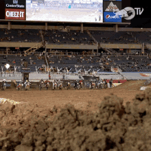 a group of dirt bike riders are lined up on a dirt track in front of a centerstate cheez-it sign