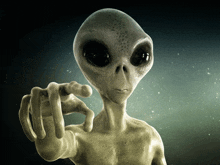 a gray alien pointing at the camera with his finger