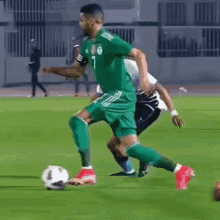 a soccer player in a green jersey with the number 1 on it is kicking a soccer ball .