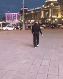 a man is walking in front of a building that says ' ukrainian borsa ' on it