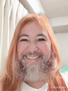 a woman with long red hair and a beard is smiling for the camera with faceapp written below her