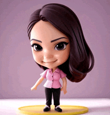 a doll with a pink shirt and black pants is on a yellow base