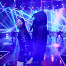 a couple of people dancing on a stage with the words nightkpop_21 on the bottom right