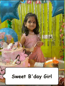 a little girl is celebrating her birthday with a cake