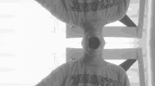 a person wearing a toronto shirt with a hole in their mouth