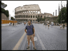 a man stands in front of the colosseum