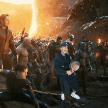 a man in a bathrobe is holding a frying pan in front of a crowd of avengers