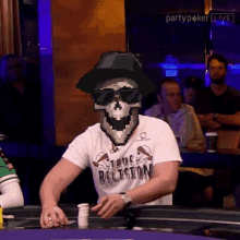 a pixelated skeleton wearing a hat and sunglasses is playing poker at a party poker live event