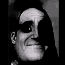 a black and white photo of a man 's face with a mask on it .