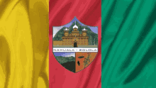 a red yellow and green flag with a coat of arms that says nahuala solola