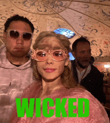 a poster for wicked with a woman wearing sunglasses