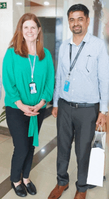 a man and a woman are standing next to each other and the man has a lanyard that says samsung