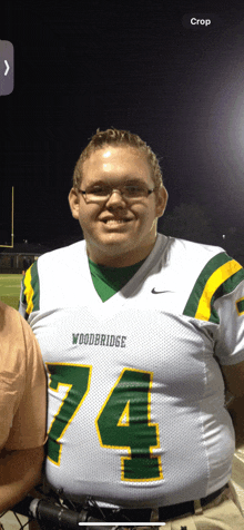 a man in a woodbridge number 74 jersey poses for a picture