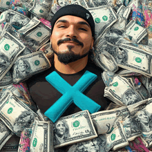 a man laying in a pile of money with a blue x