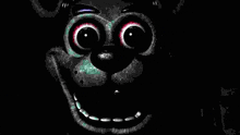 a close up of a cartoon character 's face with big eyes and a smile in the dark .