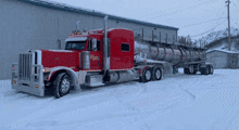 a red vanguard semi truck is parked in front of a building