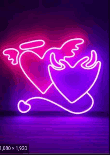 a neon sign of two hearts with wings and a tail