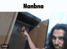 a man with long hair is opening a closet with nanbna written above him