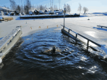 a person is swimming in a body of water with a sign that says " a " on it