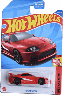 a red toyota supra hot wheels car is on a card