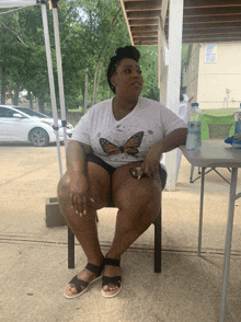 a woman sits at a table with a bottle of aquafina water