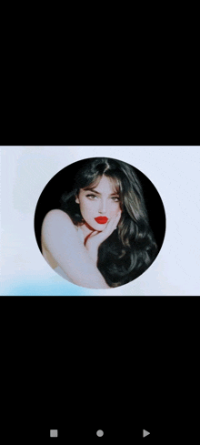 a woman with long black hair and red lipstick is in a circle