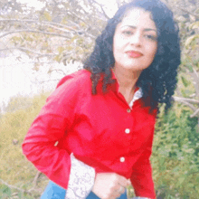 a woman in a red shirt with white buttons