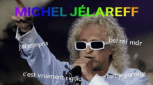 a man wearing sunglasses is singing into a microphone with the name michel jel areff written above him