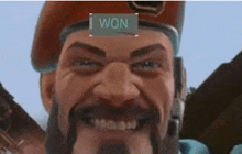 a man with a beard and a beret is smiling with a sign on his head that says `` i won '' .