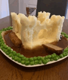 a plate of food that looks like a castle made out of mashed potatoes and gravy