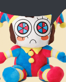 a stuffed clown with a sad face is sitting down