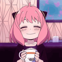 a girl with pink hair is smiling while holding a cup with icons written on it