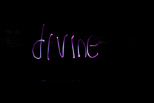 the word divine is written with purple light on a black background