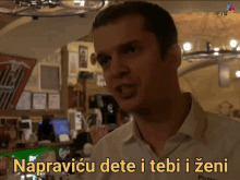 a man in a white shirt says " napravicu dete i tebi i zeni " in yellow letters