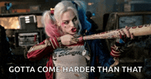 harley quinn from suicide squad is holding a baseball bat