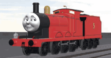 a red train has the number 5 on the side of it