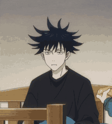 a black haired anime character sitting on a wooden bed